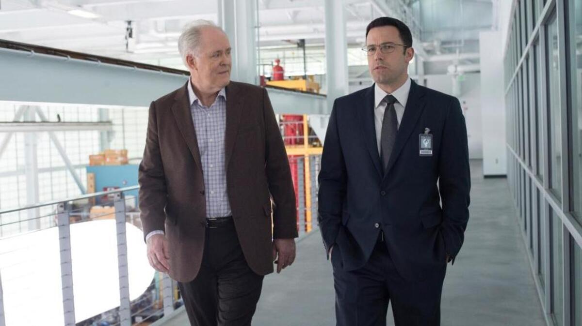 In this image released by Warner Bros. Pictures, John Lithgow, left, and Ben Affleck appear in a scene from "The Accountant."