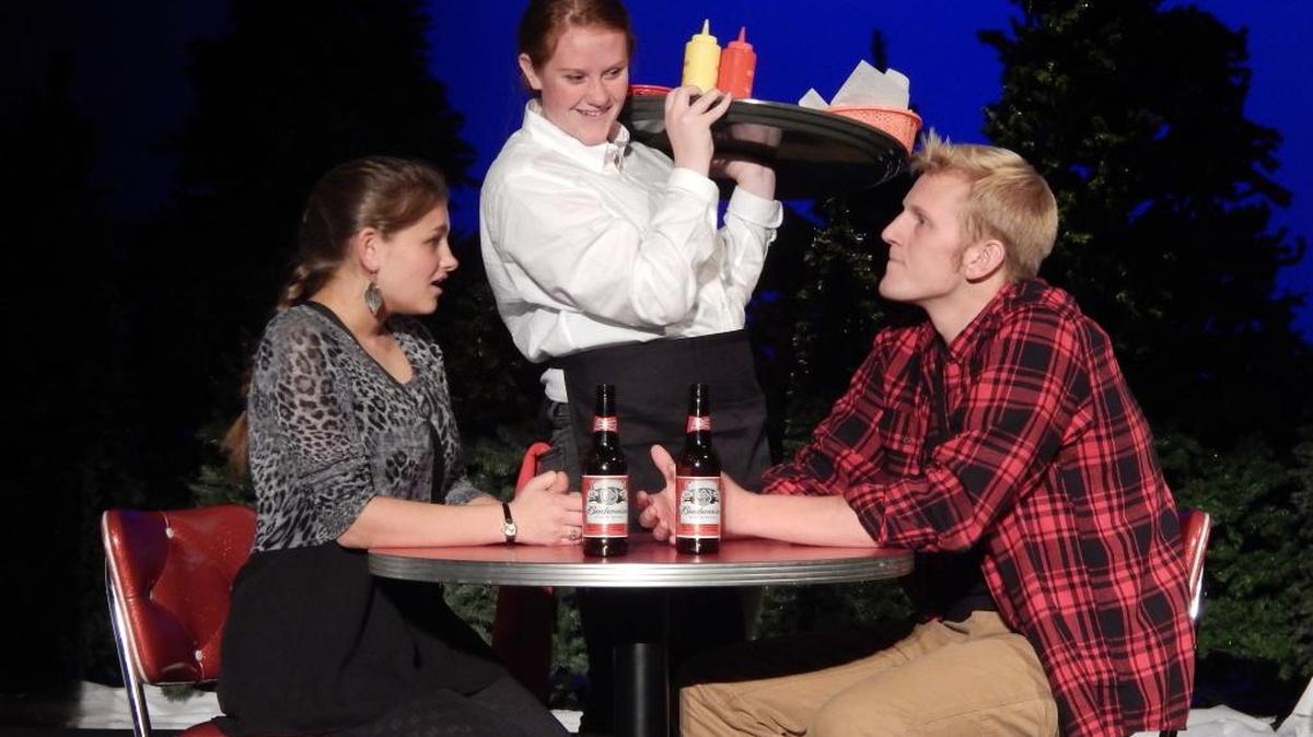 
“ALMOST, MAINE”: Jimmy (Henry Holm) runs into his ex-girlfriend Sandrine (Hannah Higgins) at the Moose Paddy restaurant where they are served by Villian (Emily Feazel) in a scene from “Almost, Maine.” Belleville West Little Theatre will present the comedic drama at 7 p.m. Thursday through Saturday at the Belleville West Performing Arts Center, 4063 Frank Scott Parkway West. Tickets are $5 for students; $8 for adults. As the Northern Lights hover in the sky above the town, Almost’s residents find themselves falling in and out of love in unexpected and often hilarious ways.
