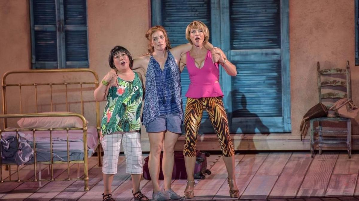 Ann Harada, left, Julia Murney and Jenny Powers perform in “Mamma Mia!” at the Muny through July 28.