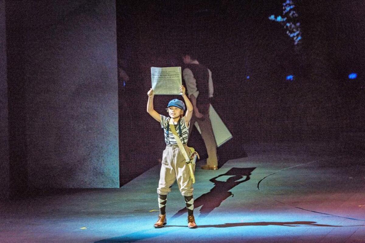 Tommy Cook portrays the newsboy.