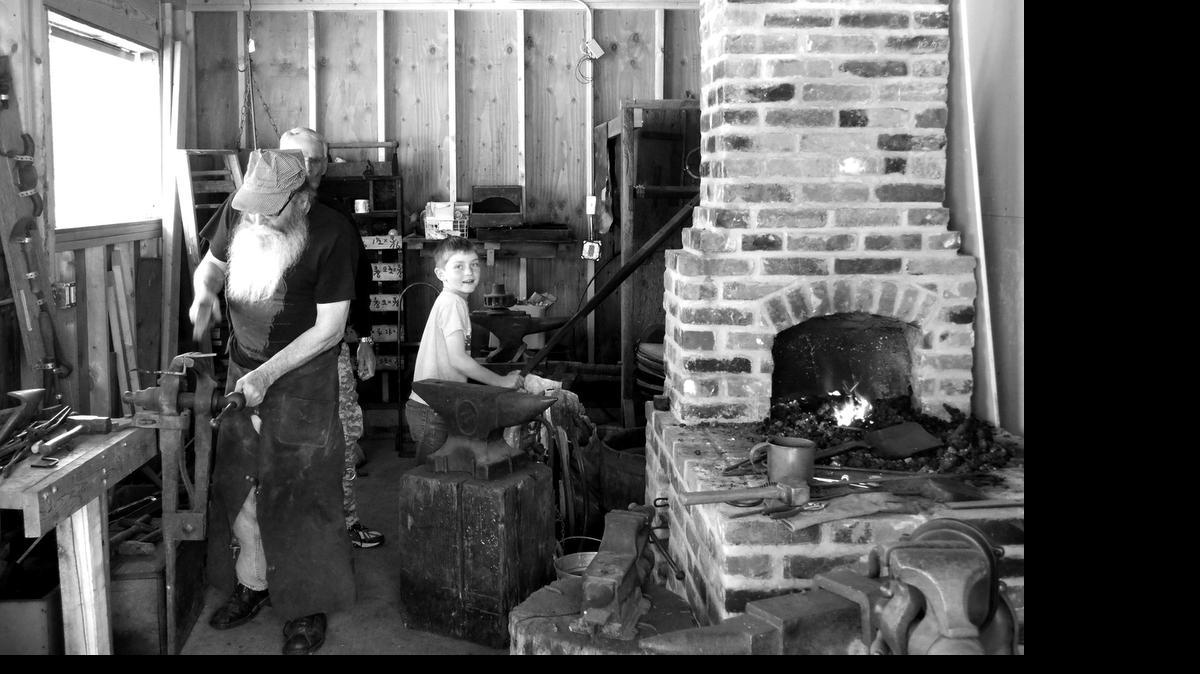 
Russell Schleicher gets a hand from Adam Esker, a second-grade student at Westhaven Elementary, in the blacksmith shop at the Labor & Industry Museum. Adam is the son of Terry and Veronica Esker.
