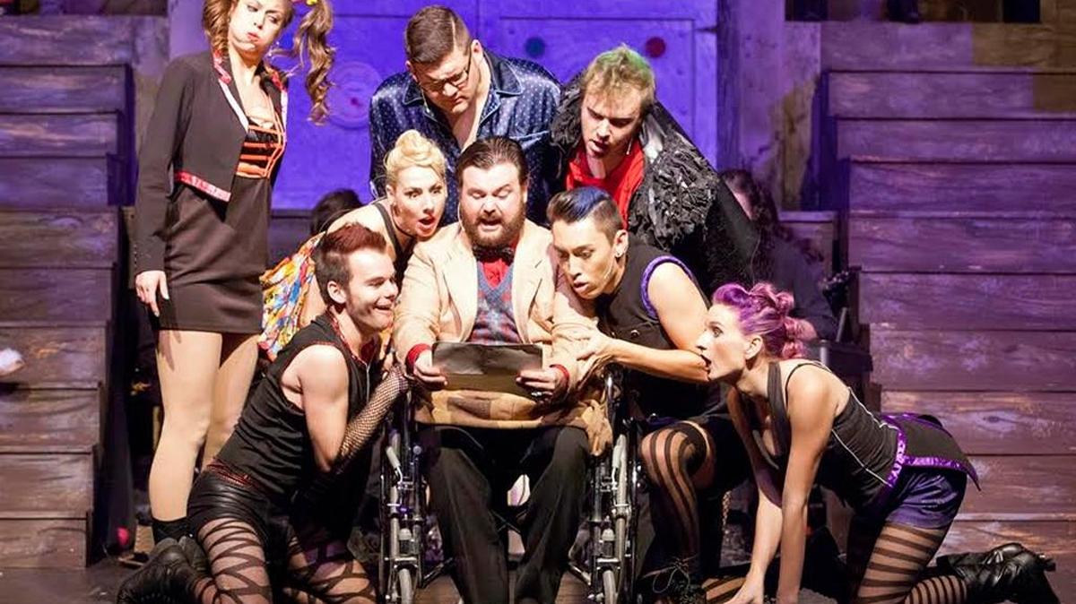 Mike Wells, of Belleville, center, is both Dr. Scott and Eddie in "The Rocky Horror Show" shown here with the Phantoms, including Dawn Schmid of Columbia, now at Stray Dog Theatre.