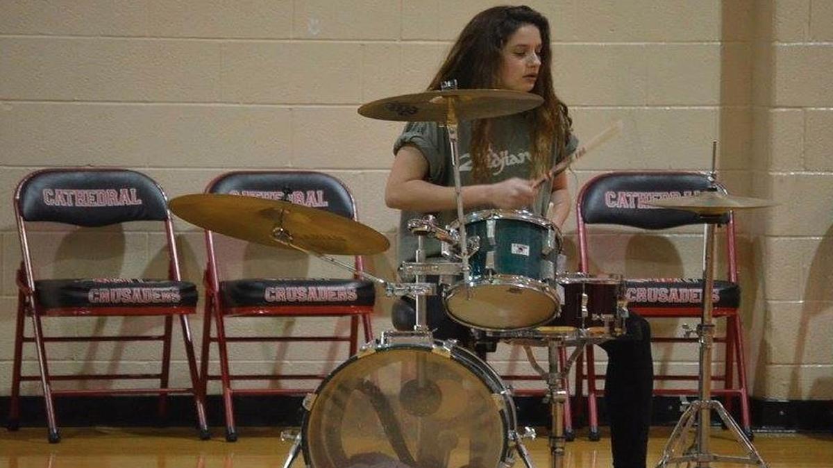 Eva Ortiz, 14, of Belleville, plays drums at the Notre Dame Academy talent show earlier this month. She learned to play on her own using dad Rick’s drumset.