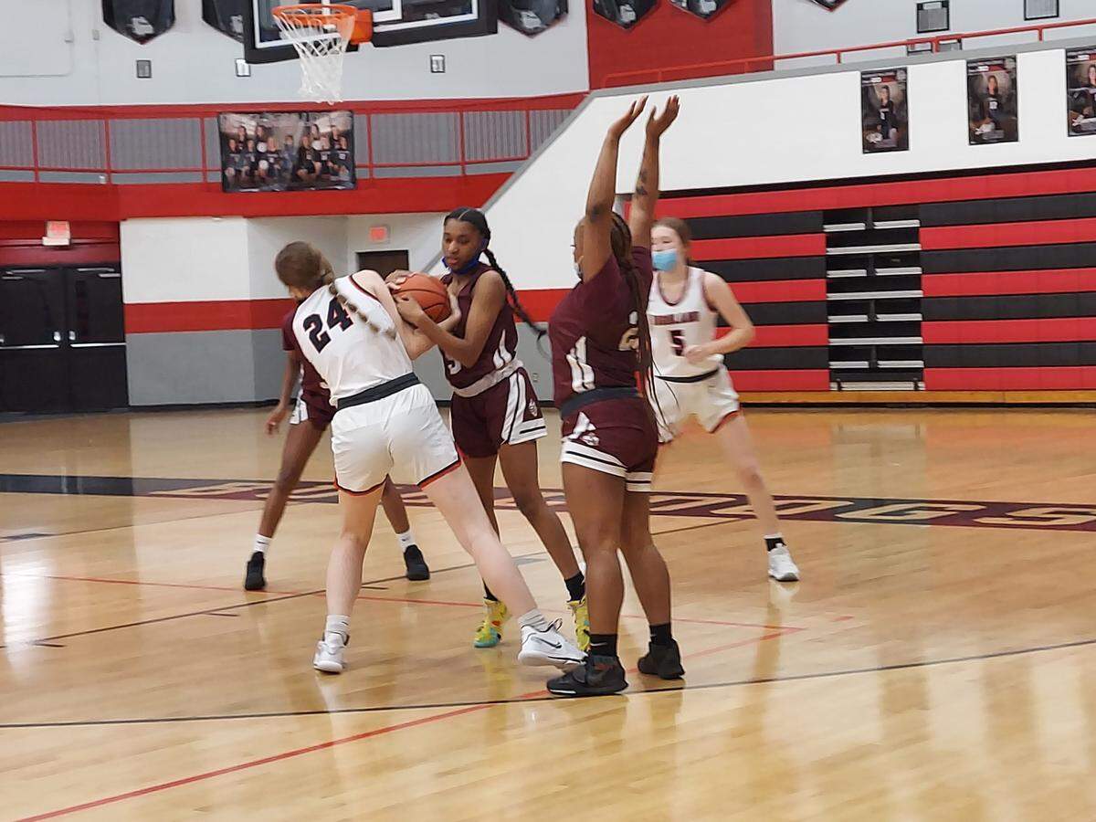 Highland sophomore Alyssa Taylor battles for a loose ball against Belleville West’s Jalynn Rook earlier this season. In more recent action, the Lady Bulldogs battled throughout but ultimately dropped a 51-42 decision to Mississippi Valley Conference rival Triad at Highland High School.