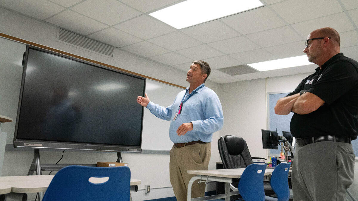 Belleville East principal Josh Lane highlights the benefits of his school’s new ViewBoards on Aug. 3, 2023 as superintendent Brian Mentzer adds context. “You can configure these however you want,” Lane said.