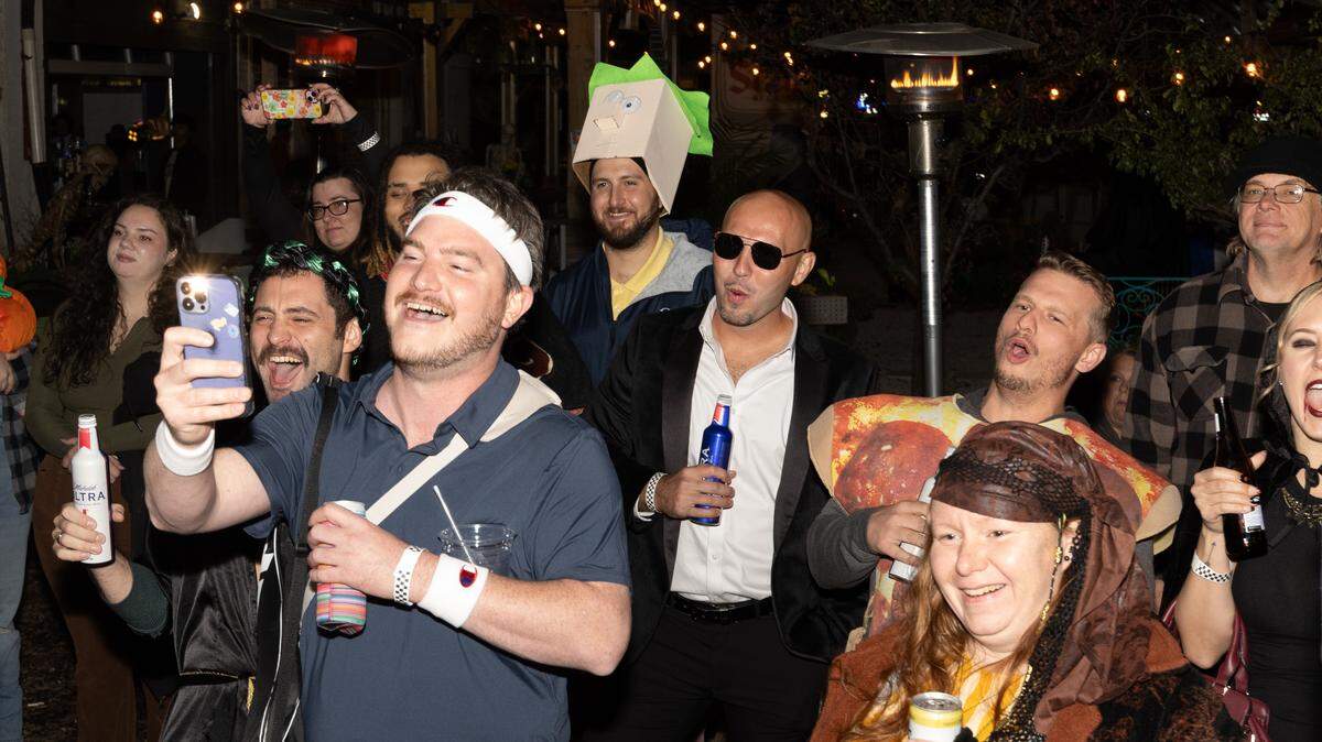 Onlookers cheer as a costume contest unfolds at Spaces during Halloween.