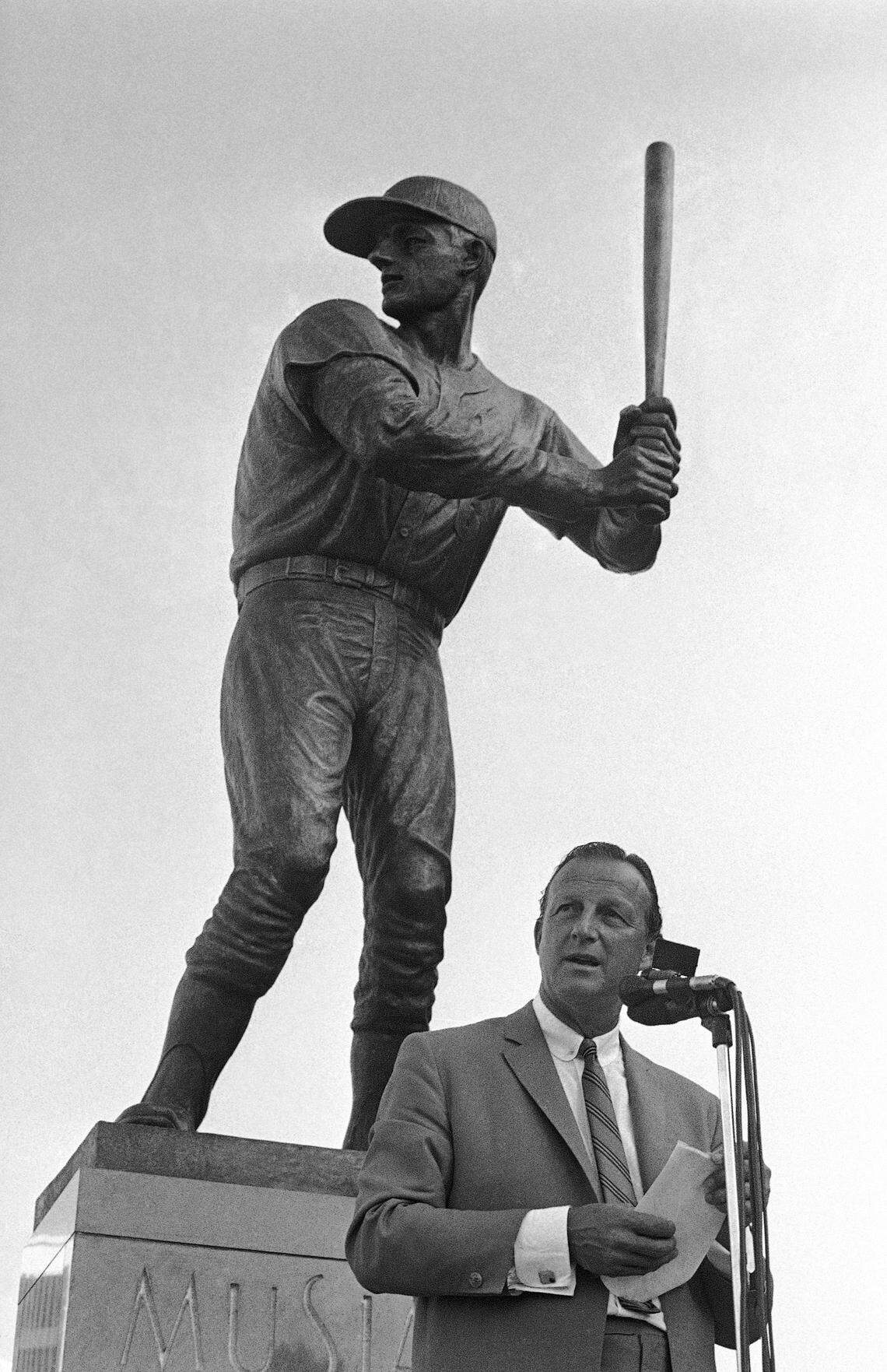 Stan Musial stand near a statue of him at the plate, outside Busch Stadium in St. Louis. (AP Photo/Fred Waters, File)