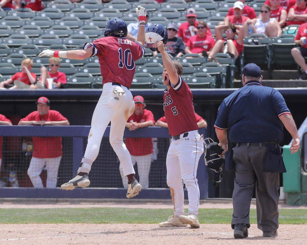 Gibault’s Daniel Darin meets Hudson Blank at home plate after Blank’s 5th inning homer during Saturday’s IHSA Class 1A state championship game against Henry H-Senachwine at Dozer Park in Peoria. Gibault went on to an 8-0 win to secure the state crown.