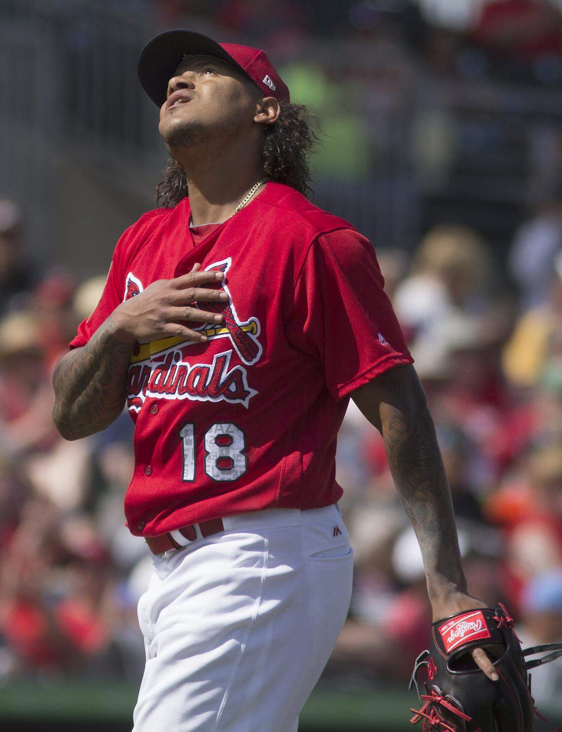 Starting pitcher Carlos Martinez looks to the heavens after finishing an inning during a spring training game in Jupiter, Florida.