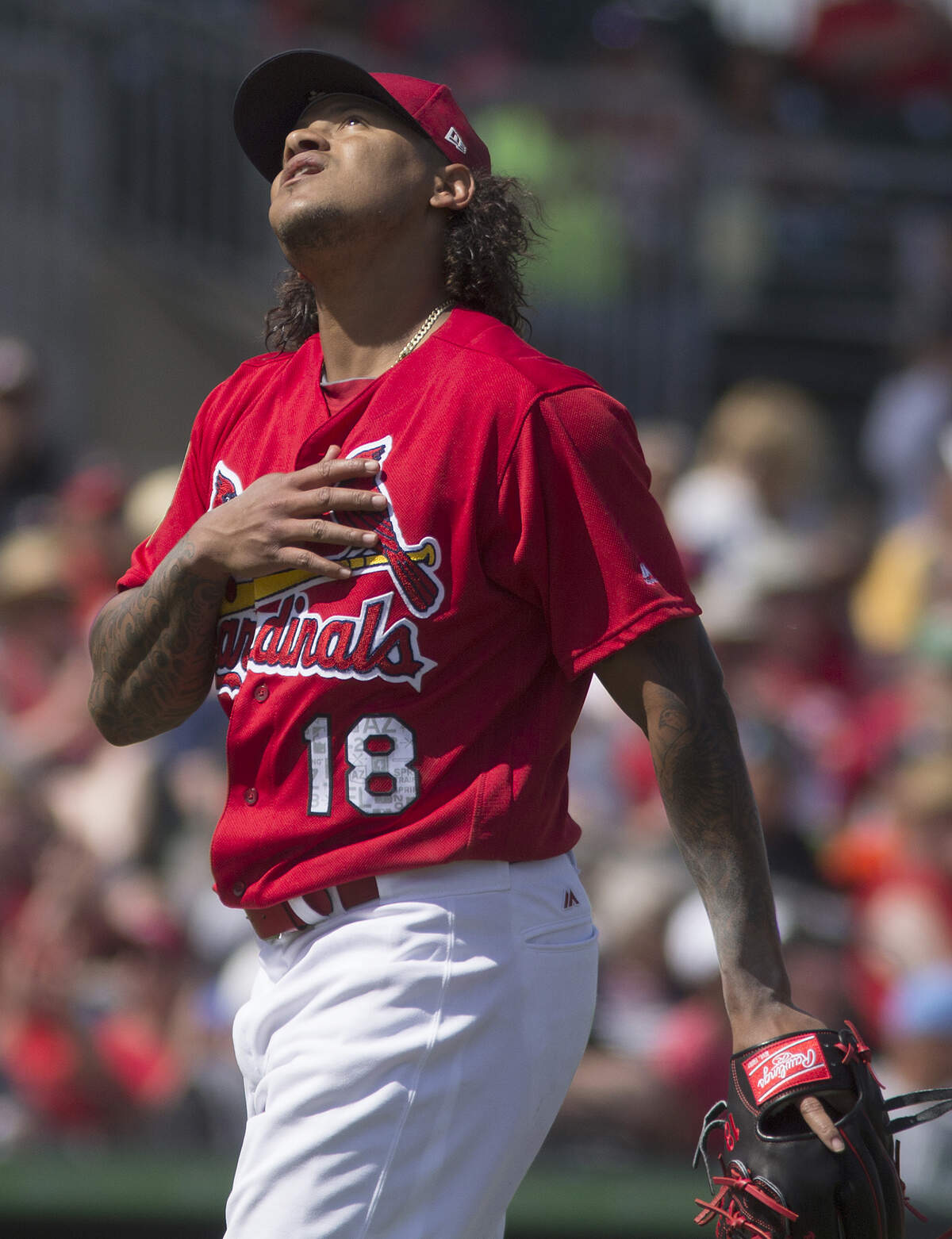 Starting pitcher Carlos Martinez looks to the heavens after finishing an inning during a spring training game in Jupiter, Florida.