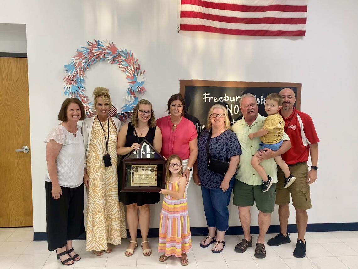Freeburg District 70 officials pose with family members of students during a flag presentation at Freeburg Primary Center last spring in this photo posted on the district’s Facebook page. The officials include, from left, School Board President Michelle Foppe, Superintendent Melanie Brink and, at far right, Financial Officer Mark Janssen.