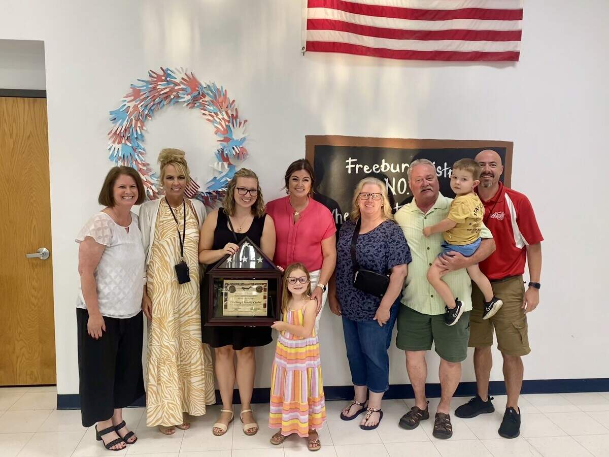 Freeburg District 70 officials pose with family members of students during a flag presentation at Freeburg Primary Center last spring in this photo posted on the district’s Facebook page. The officials include, from left, School Board President Michelle Foppe, Superintendent Melanie Brink and, at far right, Financial Officer Mark Janssen.