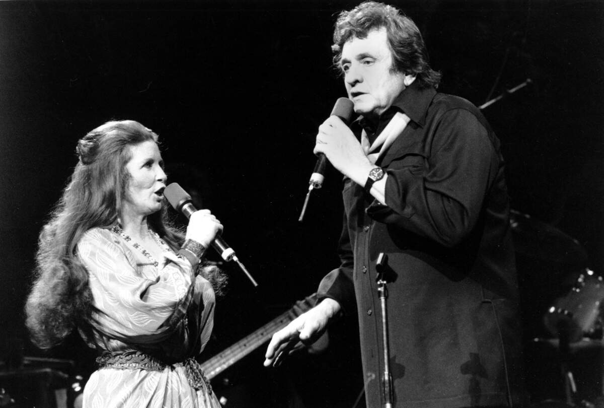 Johnny Cash sings with his wife, June Carter Cash, at Radio City Music Hall in New York City on Feb. 18, 1985, in this Associated Press file photo.