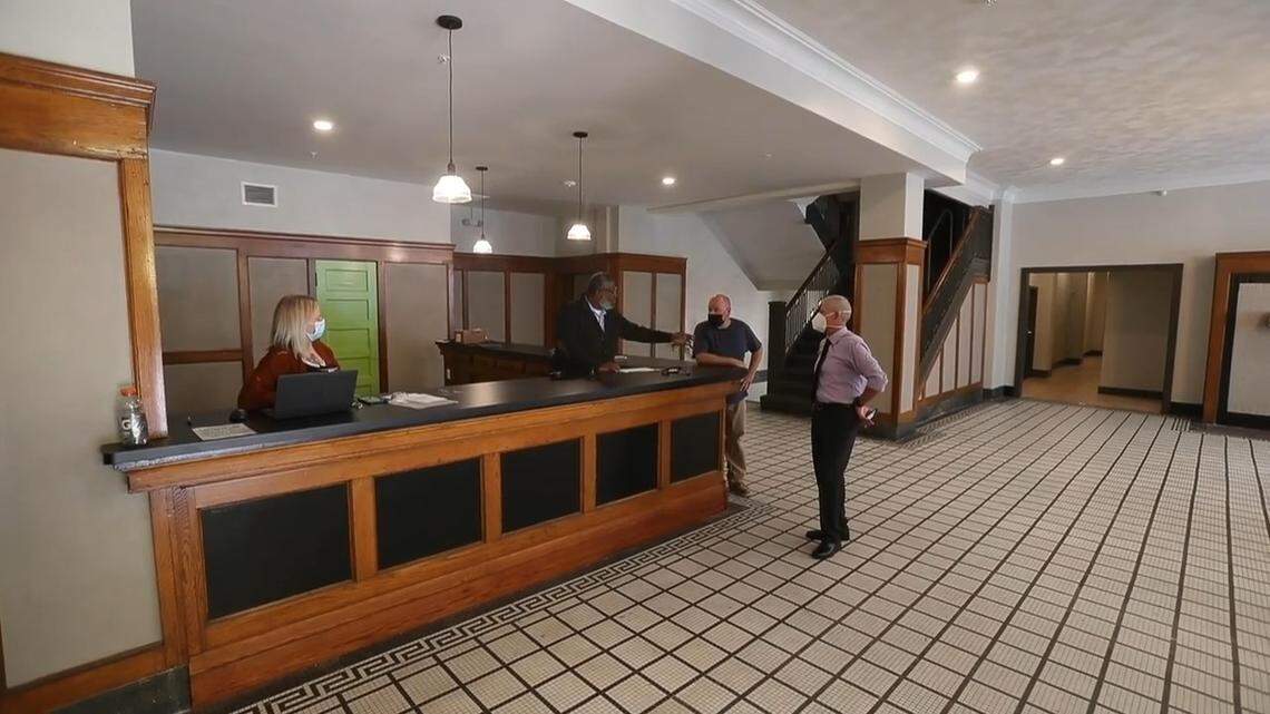 Developers renovating the former Granite City YMCA building were able to save many original features, including the lobby’s oak woodwork and reception desk and black-and-white tile floor.