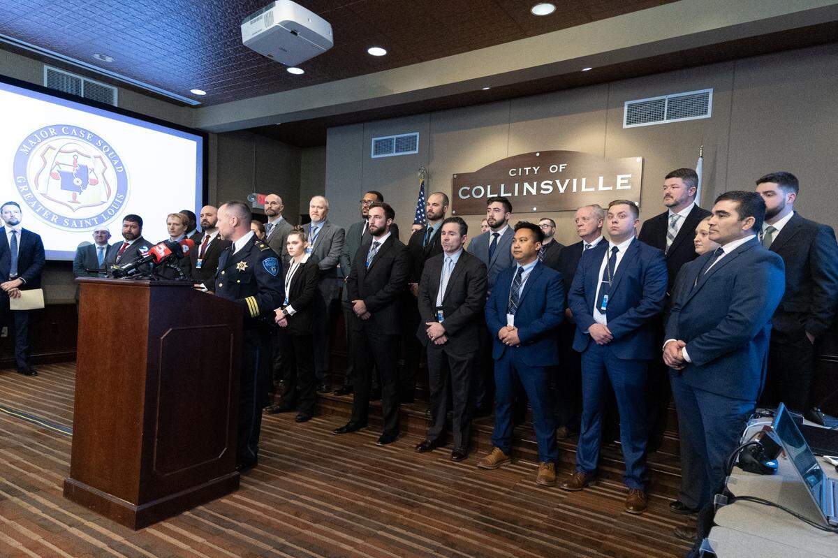 Members of the Major Case Squad of Greater St. Louis look on as Collinsville Assistant Police Chief Mark Kuechle speaks during a press conference Monday about the Portia Rowland murder.