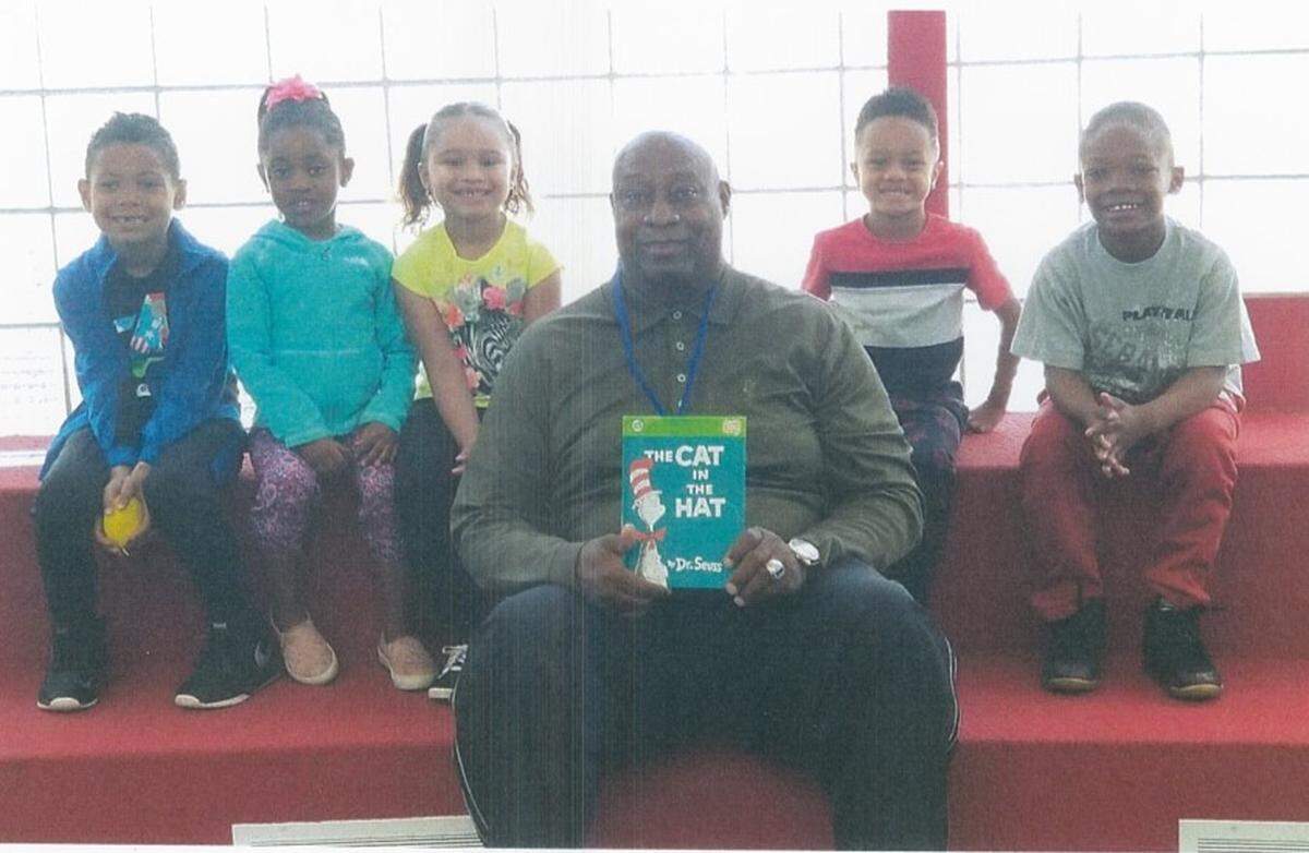 Kevin Anderson is involved in many volunteer projects, including reading books to children at East St. Louis Public Library on Saturdays.
