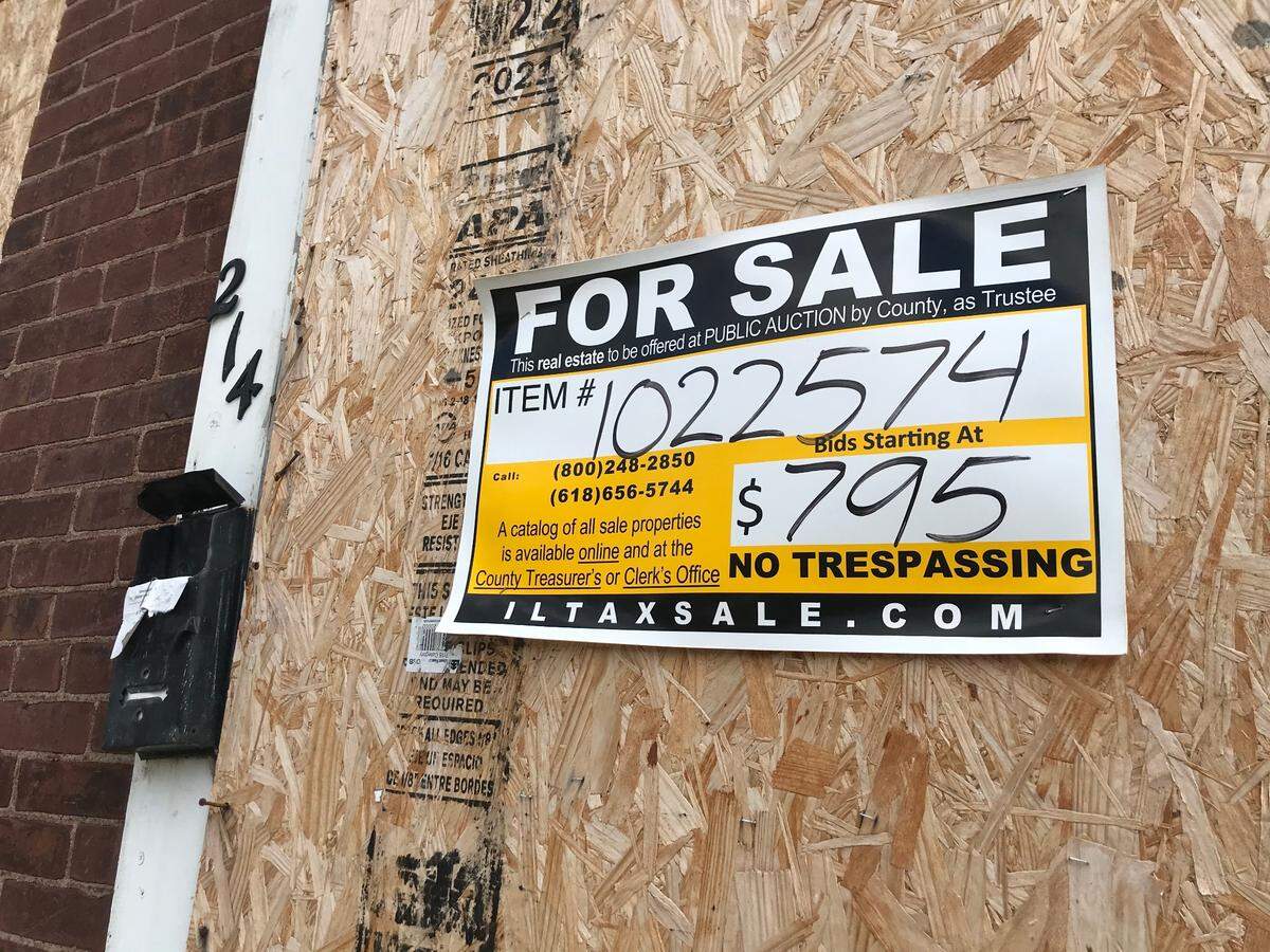 A St. Clair County auction sign remains on a German American folk house at 214 N. 11th St. in Belleville. The city bought it for $795 (minimum bid of $750 plus $50 recording fee) with plans to demolish it.