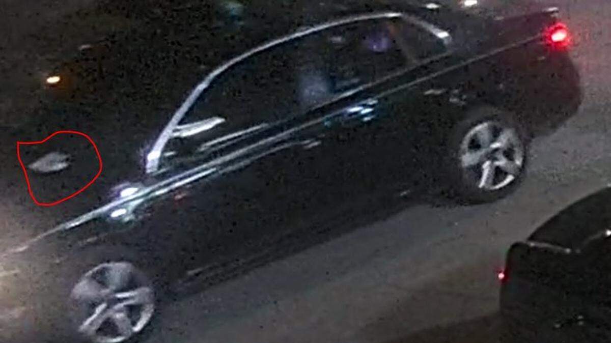 Investigators believe this black car may be connected to a fatal shooting in Madison Thursday night. The black sedan may have a defect, which appears in a security photo as a white mark across the hood.