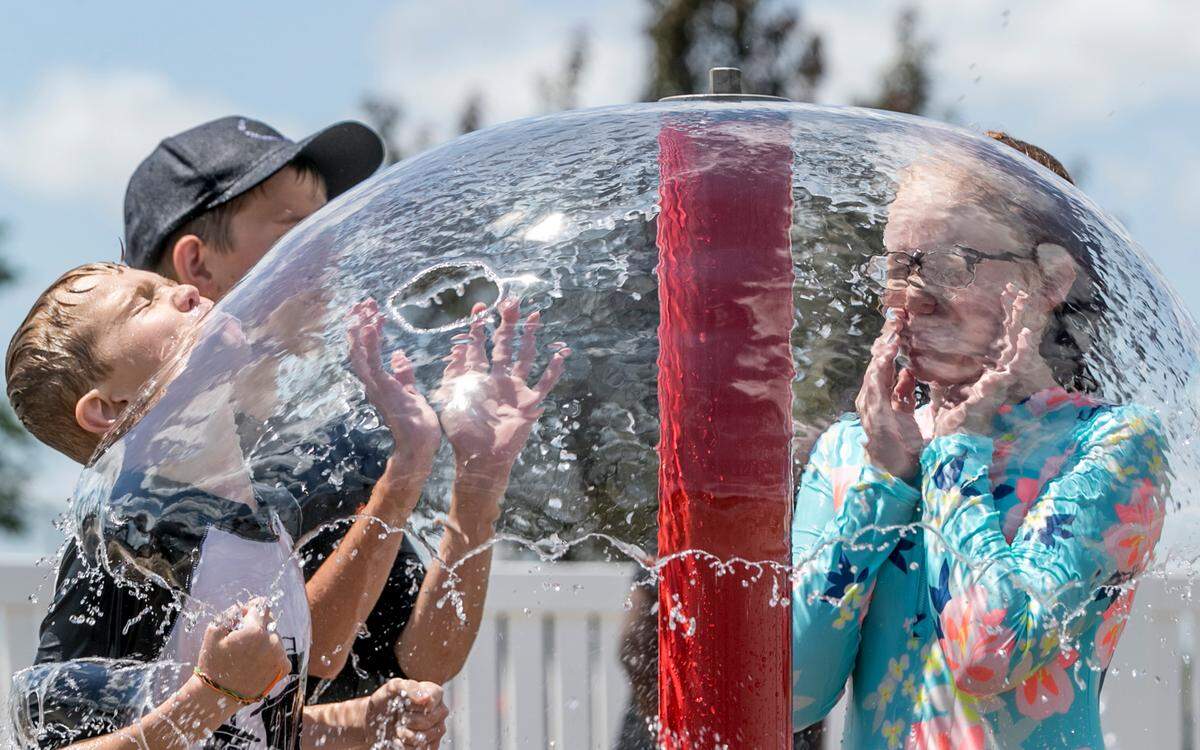 This file photo shows children playing at the Swansea splash pad in Schranz Park. With temperatures soaring into the 90s next week, metro-east splash pads and pools figure to be busy.