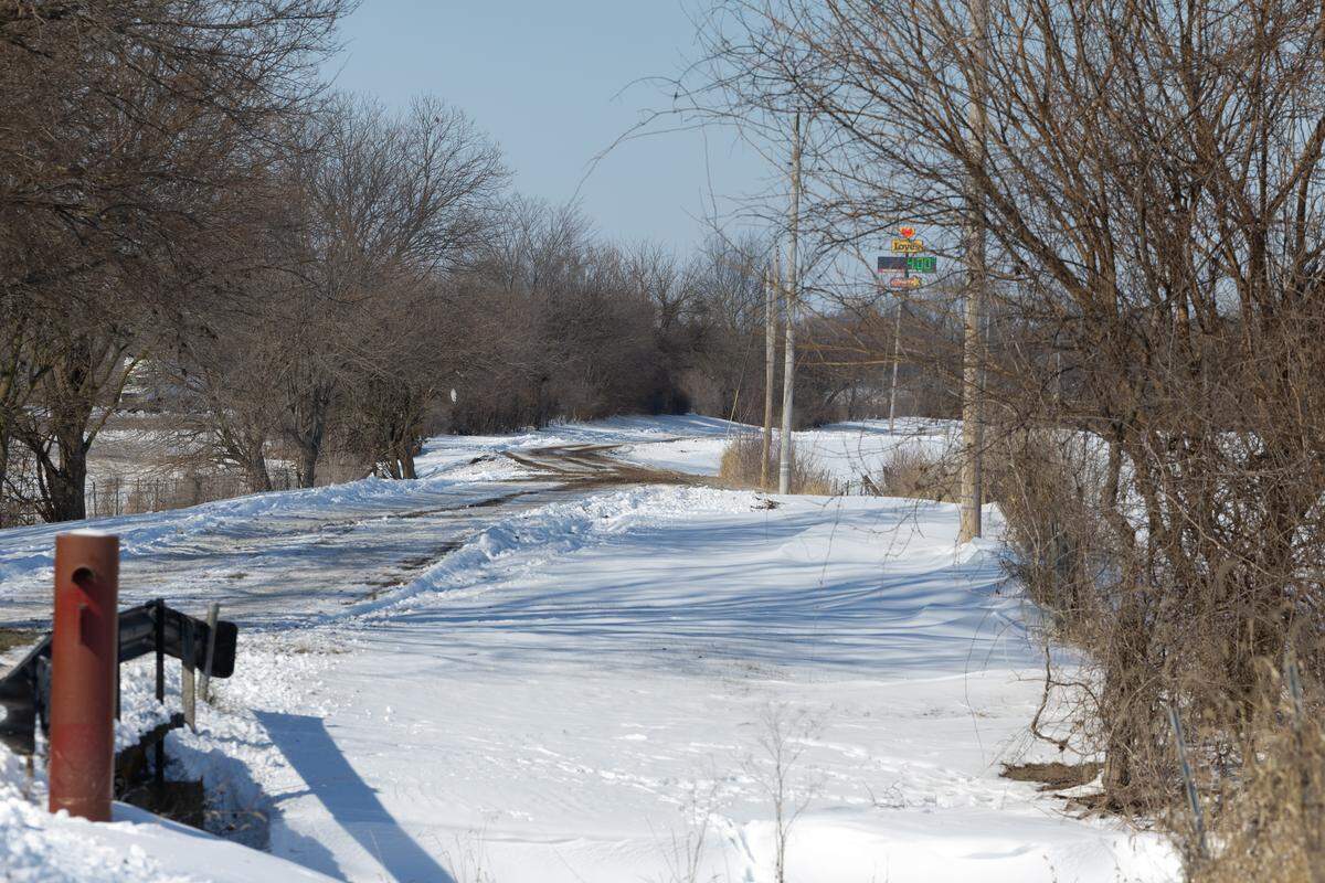 Renth Road outside New Baden on Tuesday. On Monday, a man fell through the ice on a nearby pond and did not resurface.