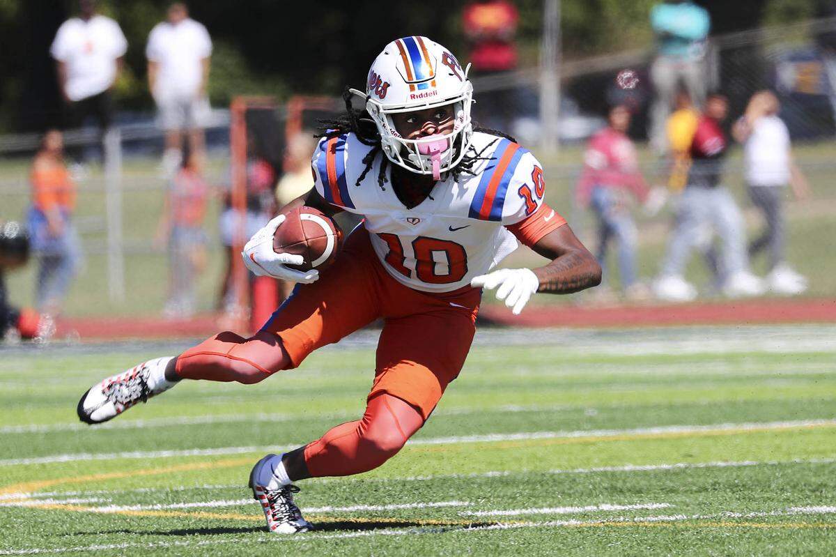 East St. Louis running back Jesse Watson carries the ball against O’Fallon during Saturday’s Southwestern Conference game. The Flyers ultimately rolled to a 60-21 victory.