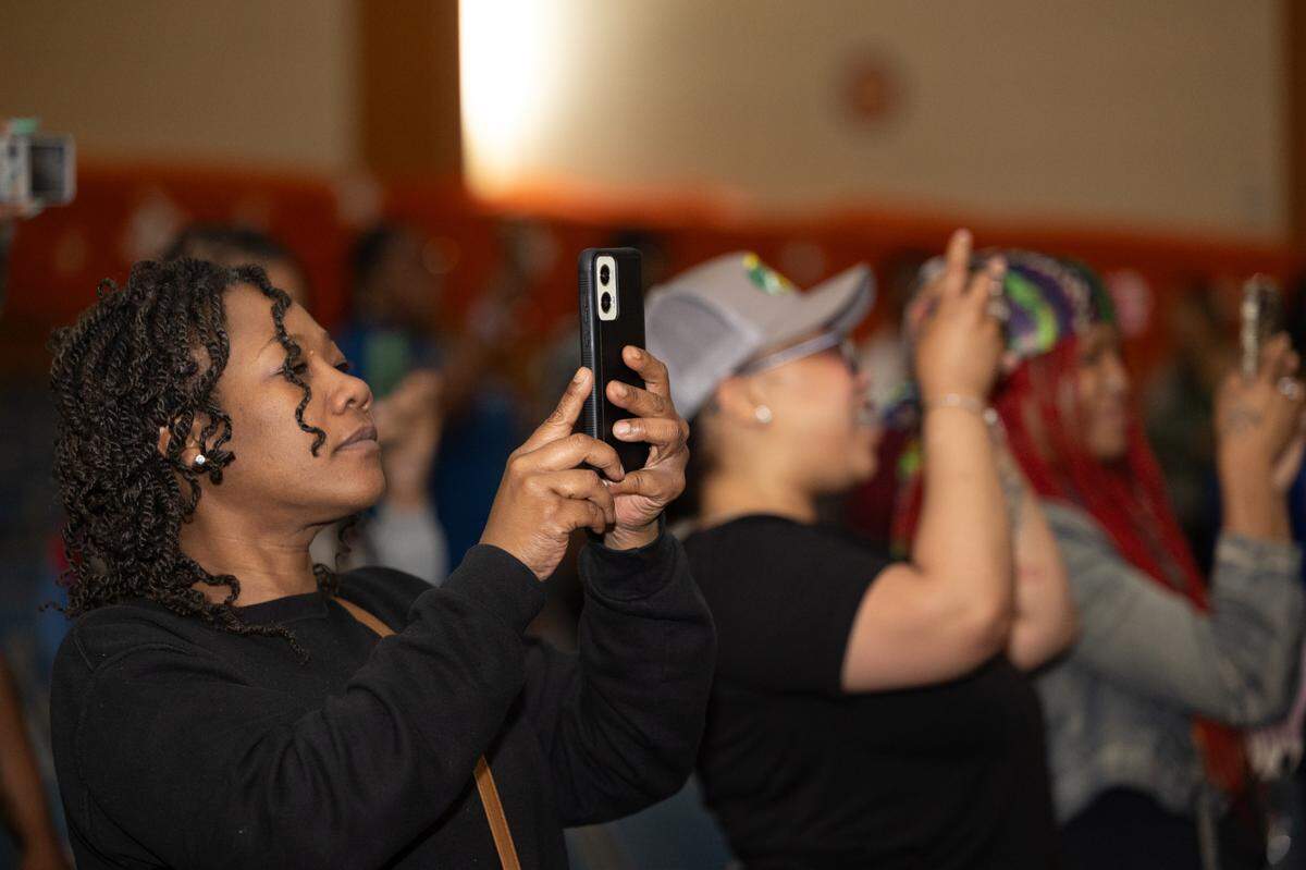 Proud parents film their children putting on a performance during an exposé on after school programs within the East St. Louis school district.