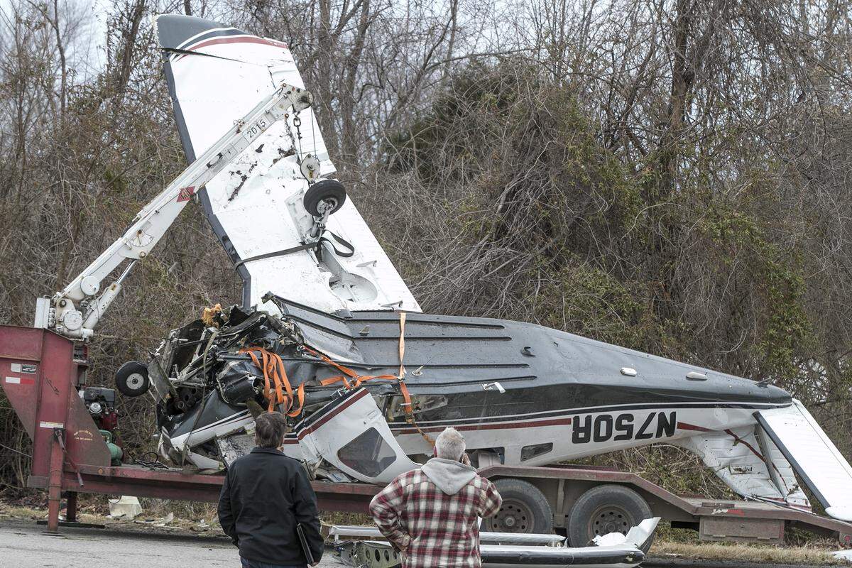 Workers prepare the wrecked plane for transport Wednesday morning. The family who survived the plane crash near Waterloo are from Alabama and were taken to area hospitals with minimal injuries.