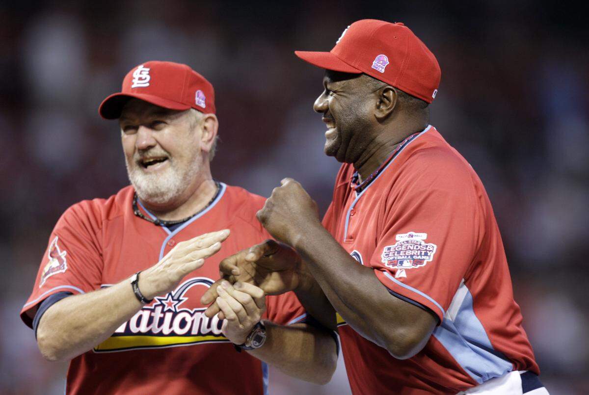 Former St. Louis Cardinals pitchers Bruce Sutter, left, and Lee Smith joke around during introductions in the All-Star Legends & Celebrity softball game at Busch Stadium on Sunday, July 12, 2009, in St. Louis. (AP Photo/Jeff Roberson)