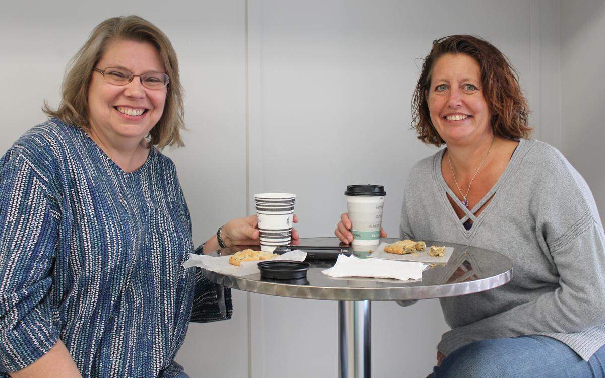 Customers Kelly Aukamp, left, and Joni Schnitzler were among the first customers at Sugar Fix Bakery in Belleville on Friday. Both ordered coffee and chocolate-chip cookies.