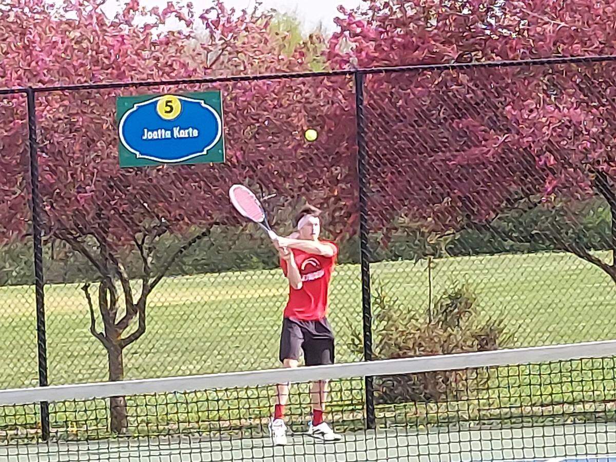 Highland senior Ben Mitchell returns a backhand shot during his No. 5 singles match against Granite City on Monday, April 25, at Highland High School. Mitchell and the Bulldogs rolled to a 7-0 non-conference victory.