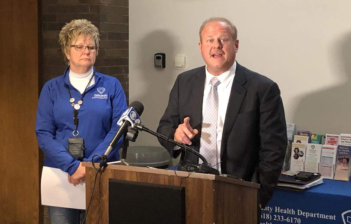 This March 14 file photo shows Barb Hohlt, executive director of St. Clair County Health Department, listening to St. Clair County Board Chairman Mark Kern announcing the county’s first two coronavirus cases at a news conference.