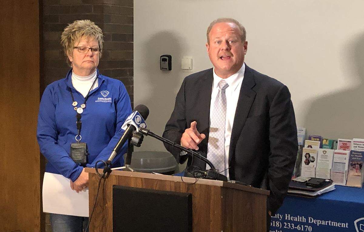 This March 14 file photo shows Barb Hohlt, executive director of St. Clair County Health Department, listening to St. Clair County Board Chairman Mark Kern announcing the county’s first two coronavirus cases at a news conference.
