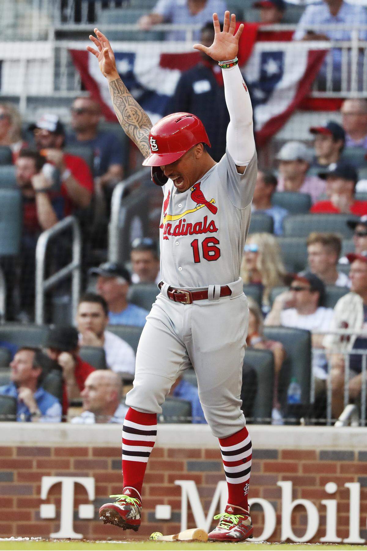 St. Louis Cardinals’ Kolten Wong celebrates after scoring on a wild pitch by Atlanta Braves pitcher Max Fried during the first inning of Game 5 of their National League Division Series baseball game Wednesday, Oct. 9, 2019, in Atlanta. (AP Photo/John Bazemore)