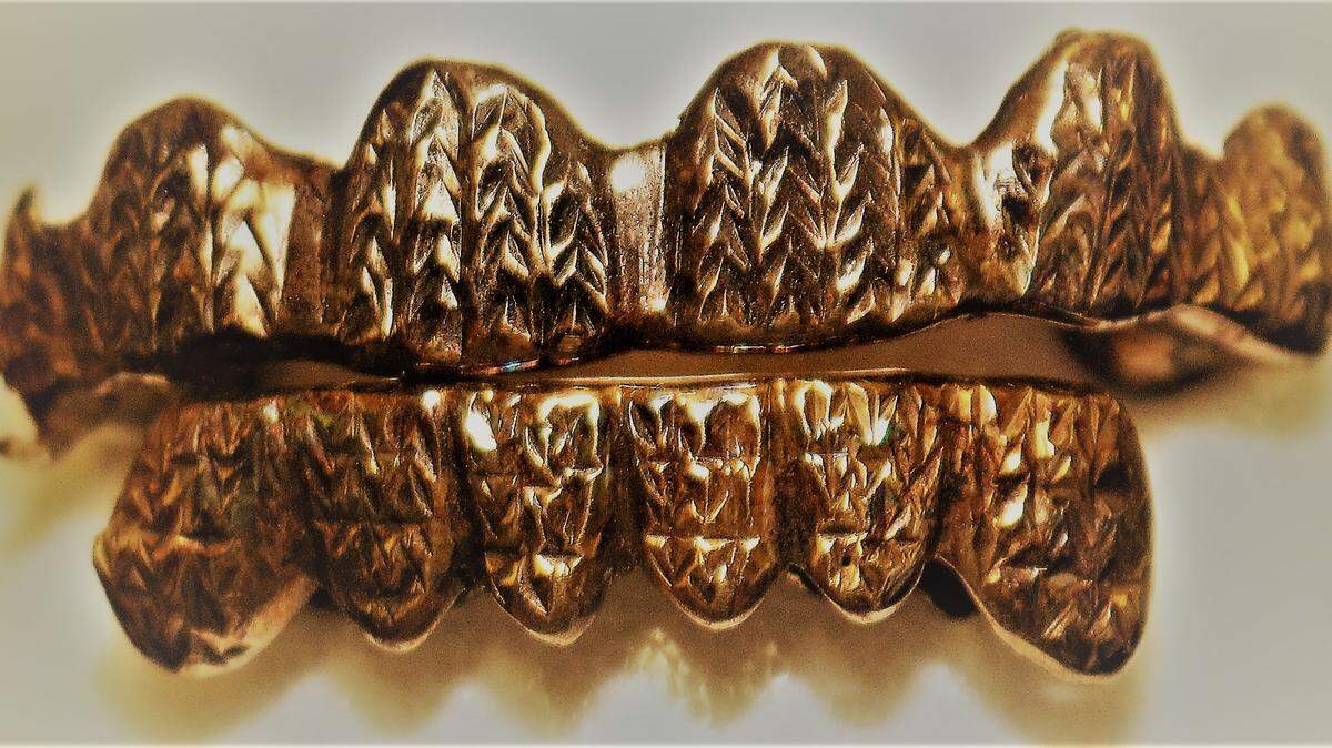 Police are asking for the public’s help in identifying a person they say was killed earlier this week in Washington Park by releasing photos of a unique dental grill the person was wearing.