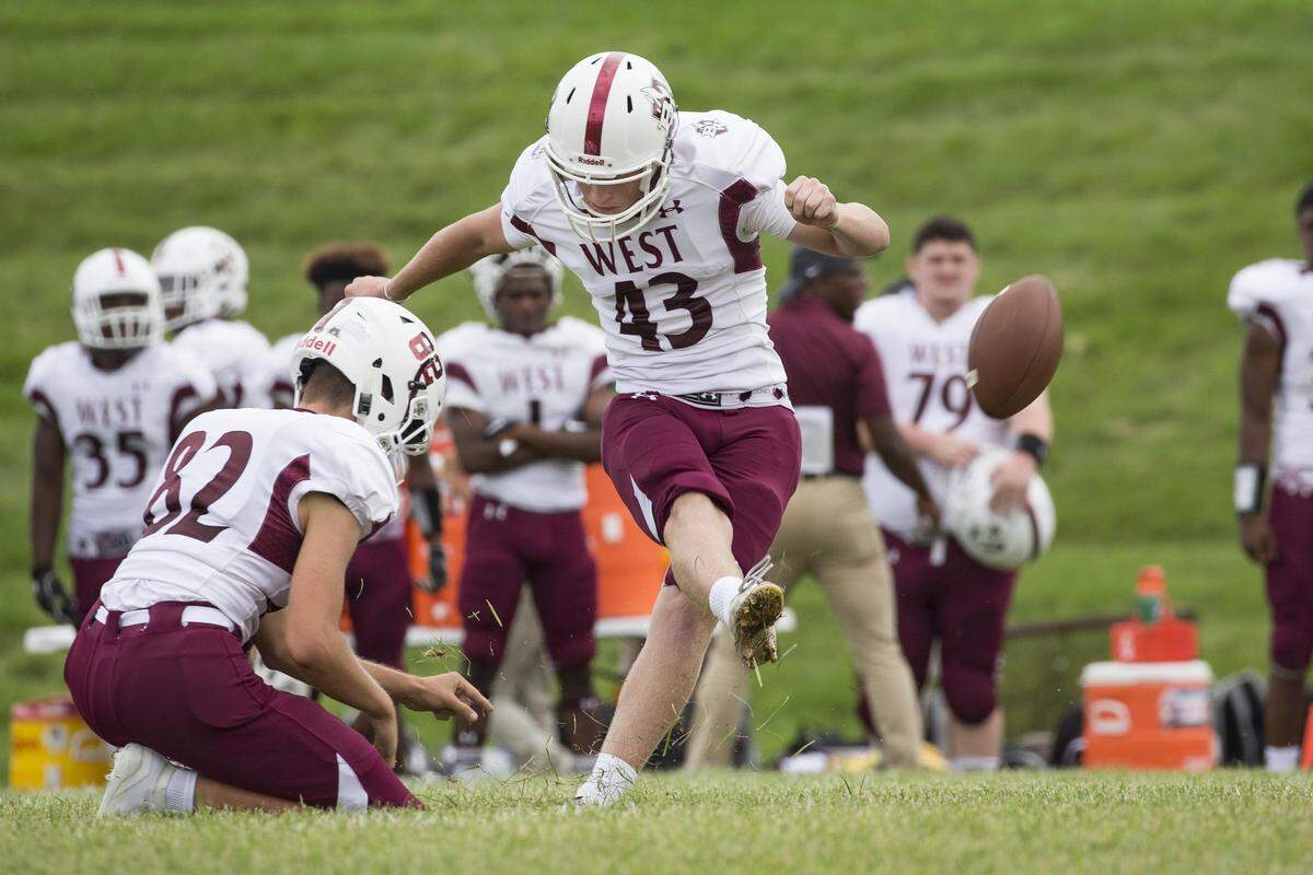 Belleville West’s Logan Seibert attempts a field goal during Belleville West’s 40-2 defeat of Riverview Gardens on Saturday. Seibert booted two field goals.