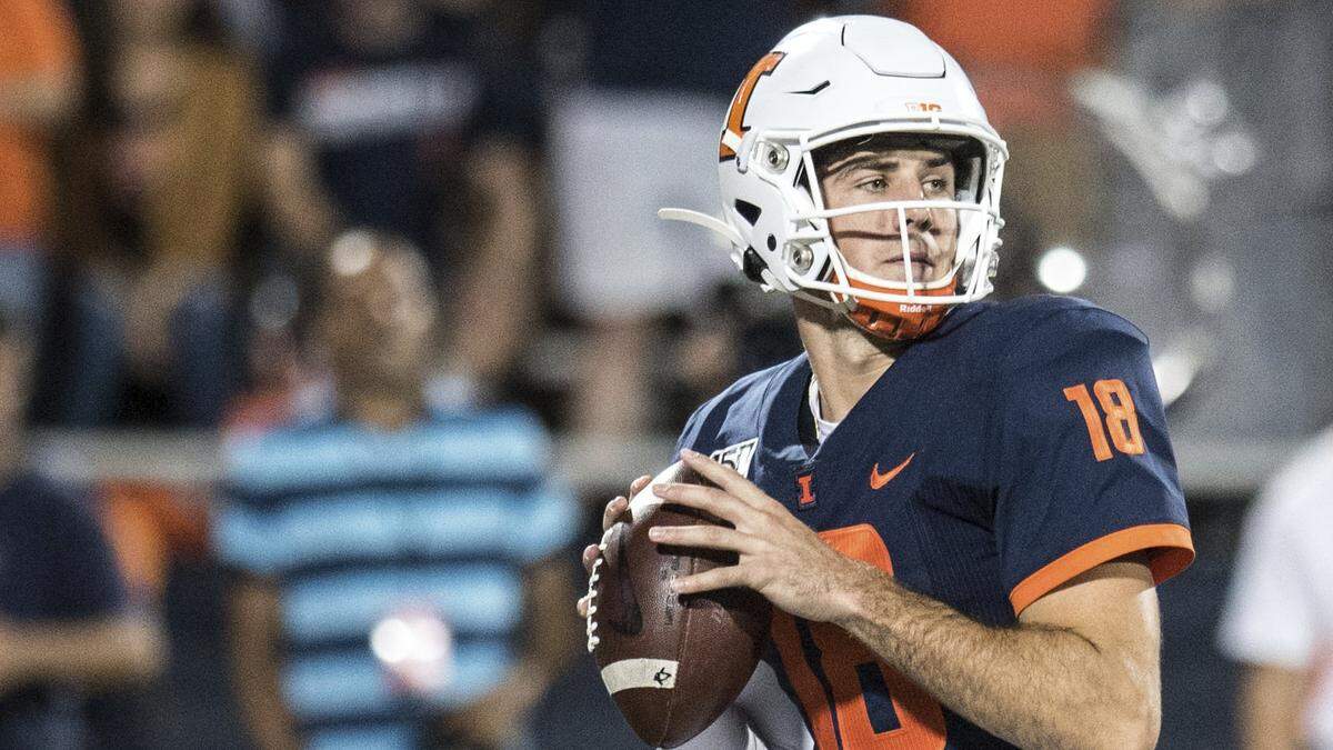 Illinois quarterback Brandon Peters looks to convert a pass against Nebraska during a game in 2019. Peters helped lead the Fighting Illini to five wins in 2022 under first-year coach Bret Bielema.