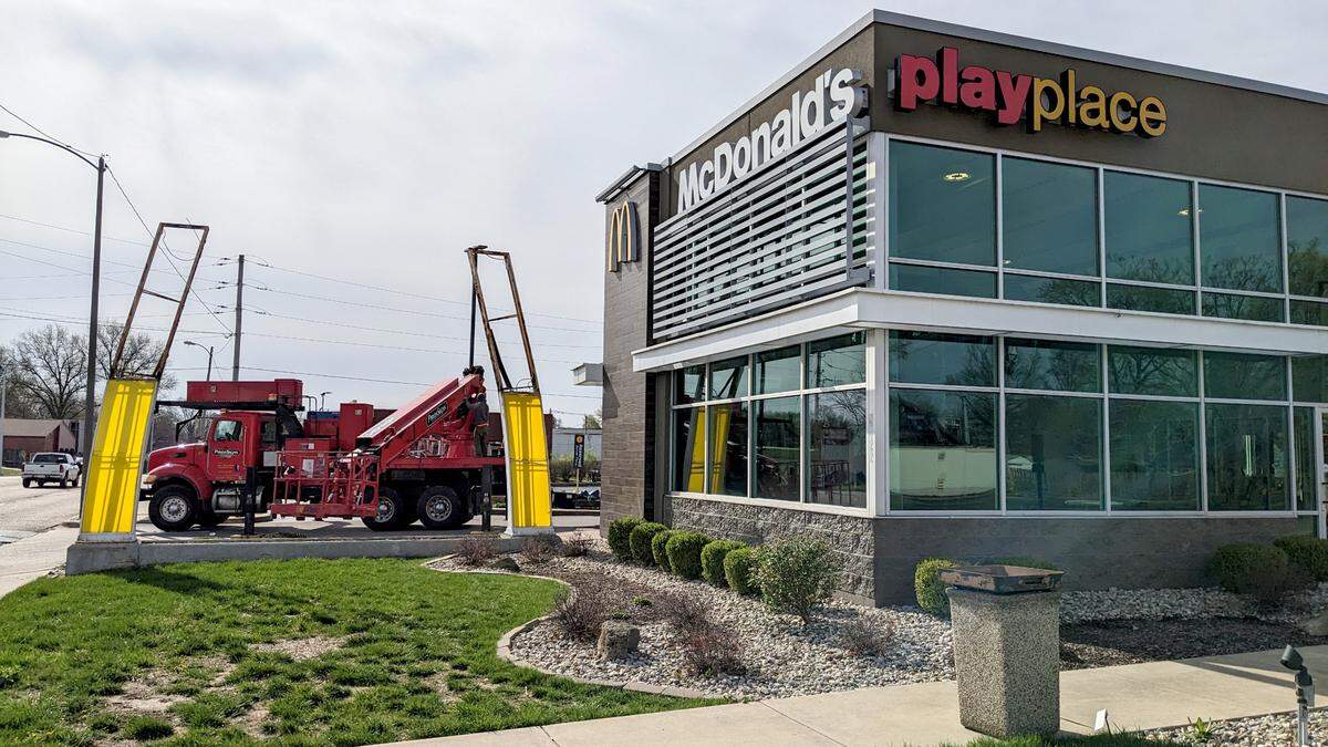 Piros Signs takes down the arch sign at the recently closed McDonald’s on West Main Street in Belleville.