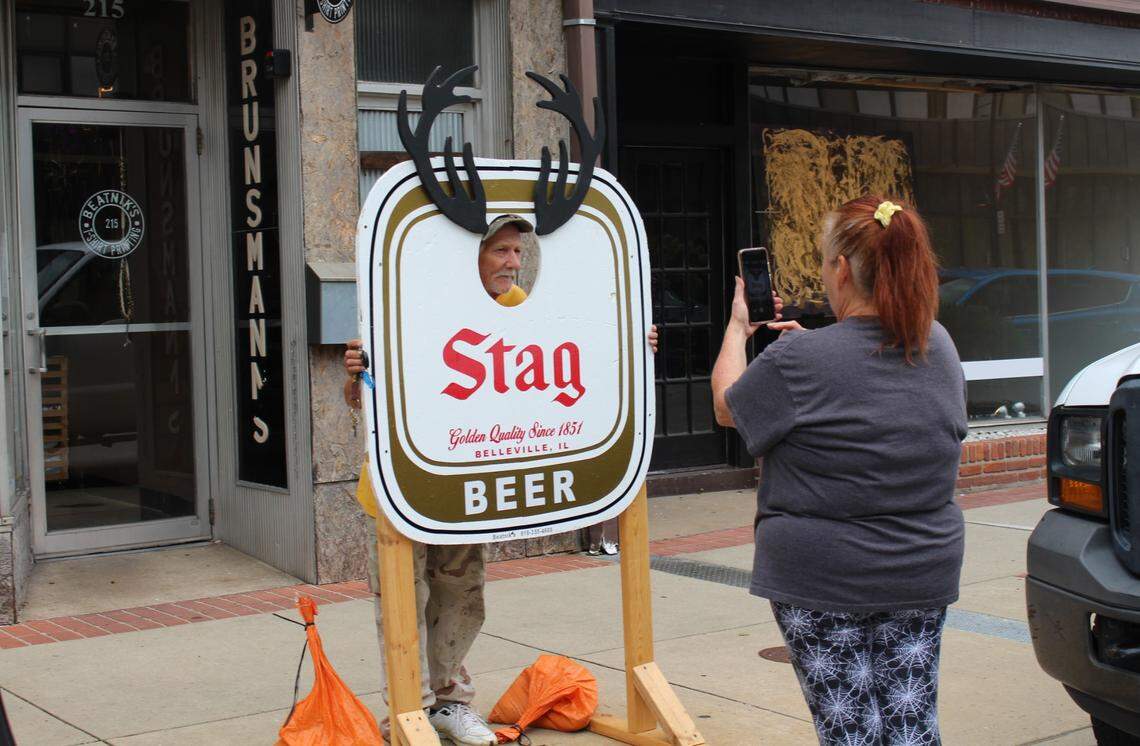 Tina Hofmeister takes a photo of her boyfriend, John Vahlkamp, putting his face into a photo board outside Beatnik’s in downtown Belleville. The T-shirt shop specializes in Stag beer clothing.