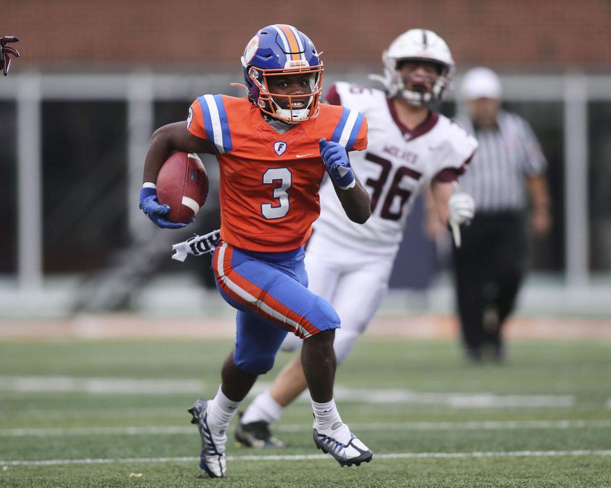 East St. Louis wide receiver Christopher Bennett Jr. carries the ball during the IHSA Class 6A state championship game against Prairie Ridge. The Flyers will be honored during a victory parade/celebration Friday.