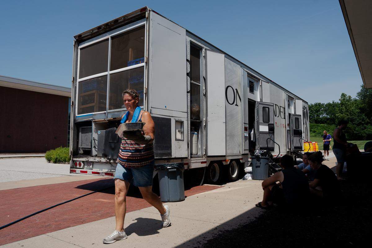 Natasja de Bruin carries a tray of sausage to the breakfast line on Tuesday, July 22, 2025, at Pattonville High School in Maryland Heights.
