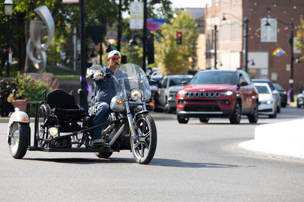Brad Henke rides his custom-built motorcycle around Belleville Public Square. After his accident, Henke wasn’t sure if he would ever ride a motorcycle again. Undeterred by hardship, he met with a friend and built a tailored side car that adds balance and a place for him to put his wheelchair.