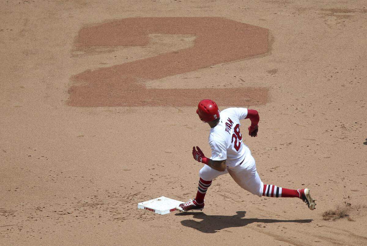 Tommy Pham rounds second as he advances from first to third on June 7, 2018. The Busch Stadium grounds crew placed a No. 2 in the infield dirt behind second base in honor of Hall of Famer Red Schoendienst who passed away the previous day.