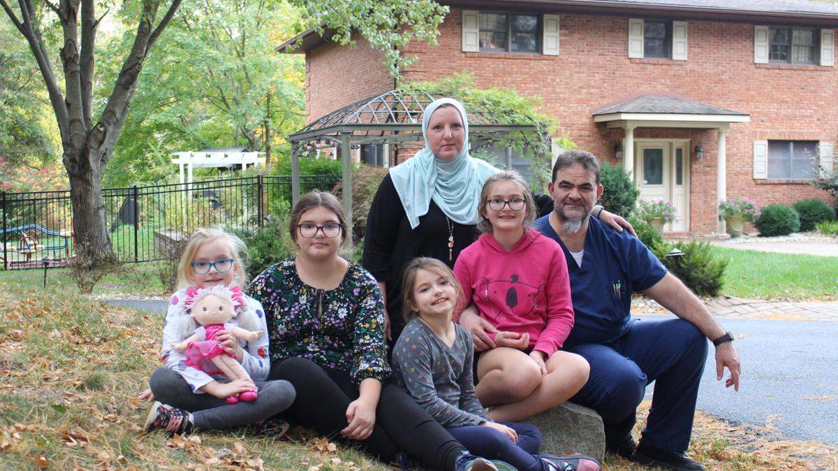 Crista and Abdul Jamous are pictured with their four daughters, left to right, Mena, Iya, Meera and Suffa, in front of their home in Kimberly Lake Estates in Swansea. They are having a dispute with their neighbors involving use of an old farm road.