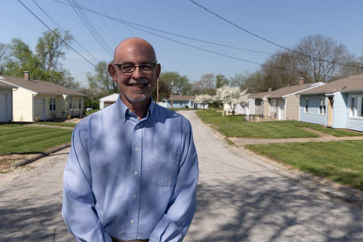 Paul Wibbenmeyer, executive director of St. Clair Associated Vocational Enterprises (SAVE), near Belleville, stands in front of small homes that once housed adults with developmental disabilities.