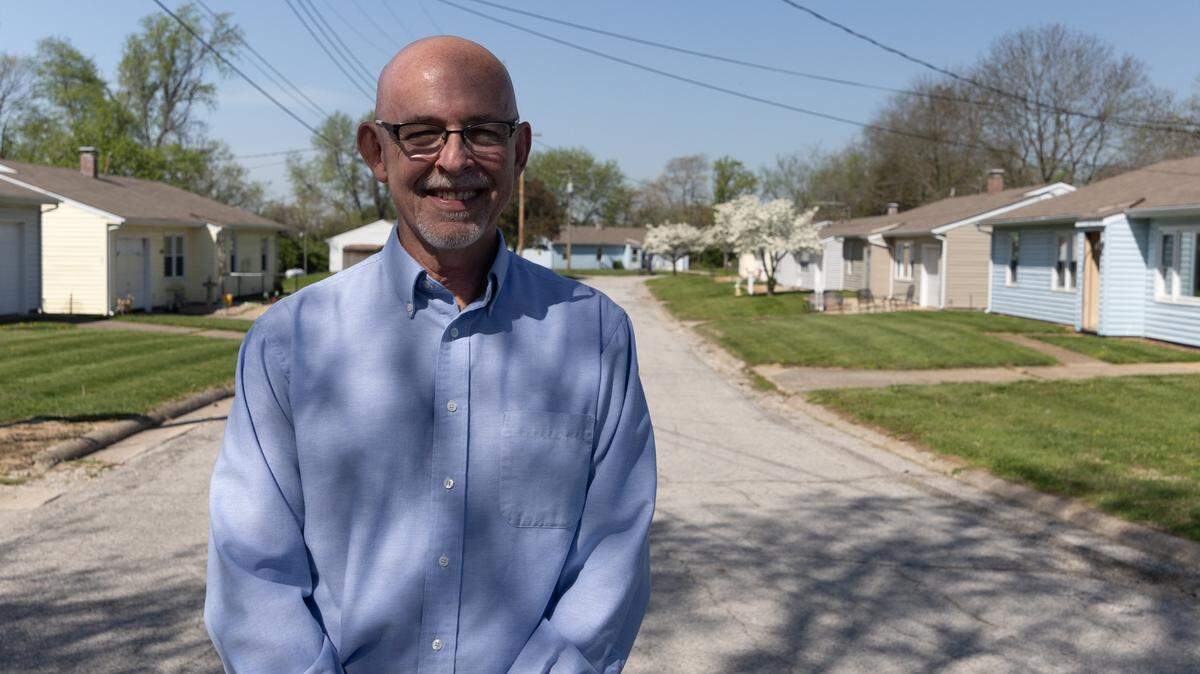 Paul Wibbenmeyer, executive director of St. Clair Associated Vocational Enterprises (SAVE), near Belleville, stands in front of small homes that once housed adults with developmental disabilities.