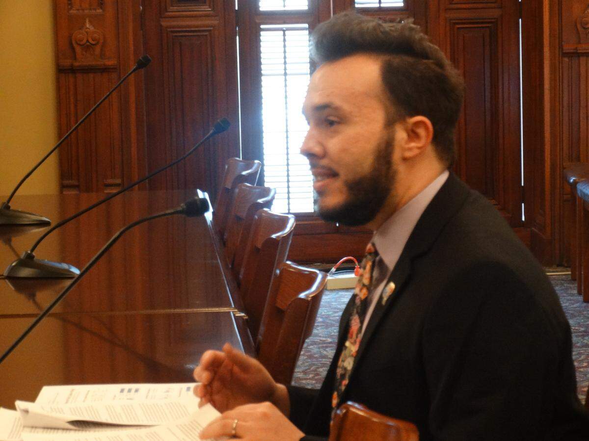 Justin Mendoza, state partnerships manager for Families USA, testifies before a House committee Wednesday in Springfield in favor of state regulations to hold down the rising cost of prescription drugs.