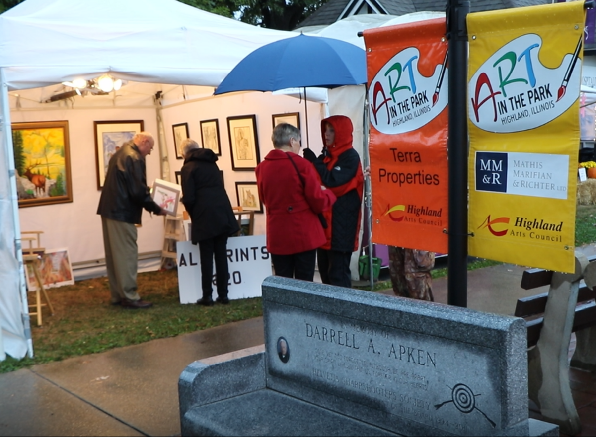 Attendees at the 15th annual Highland Art in the Park’s VIP preview show bundled up Friday, Oct. 12, as cold weather and rain persisted.