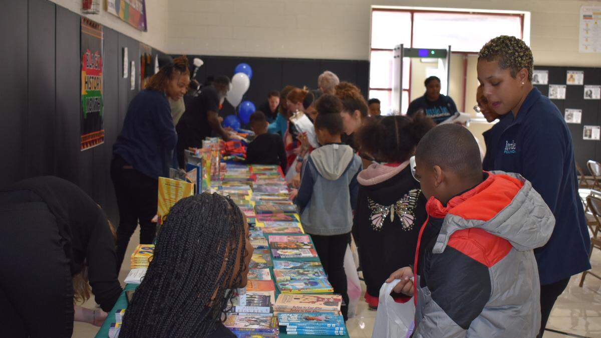 Students at Annette Officer Elementary School in East St. Louis, Ill., get books with the help of staff and volunteers from the Little Bit Foundation on Feb. 9, 2024.