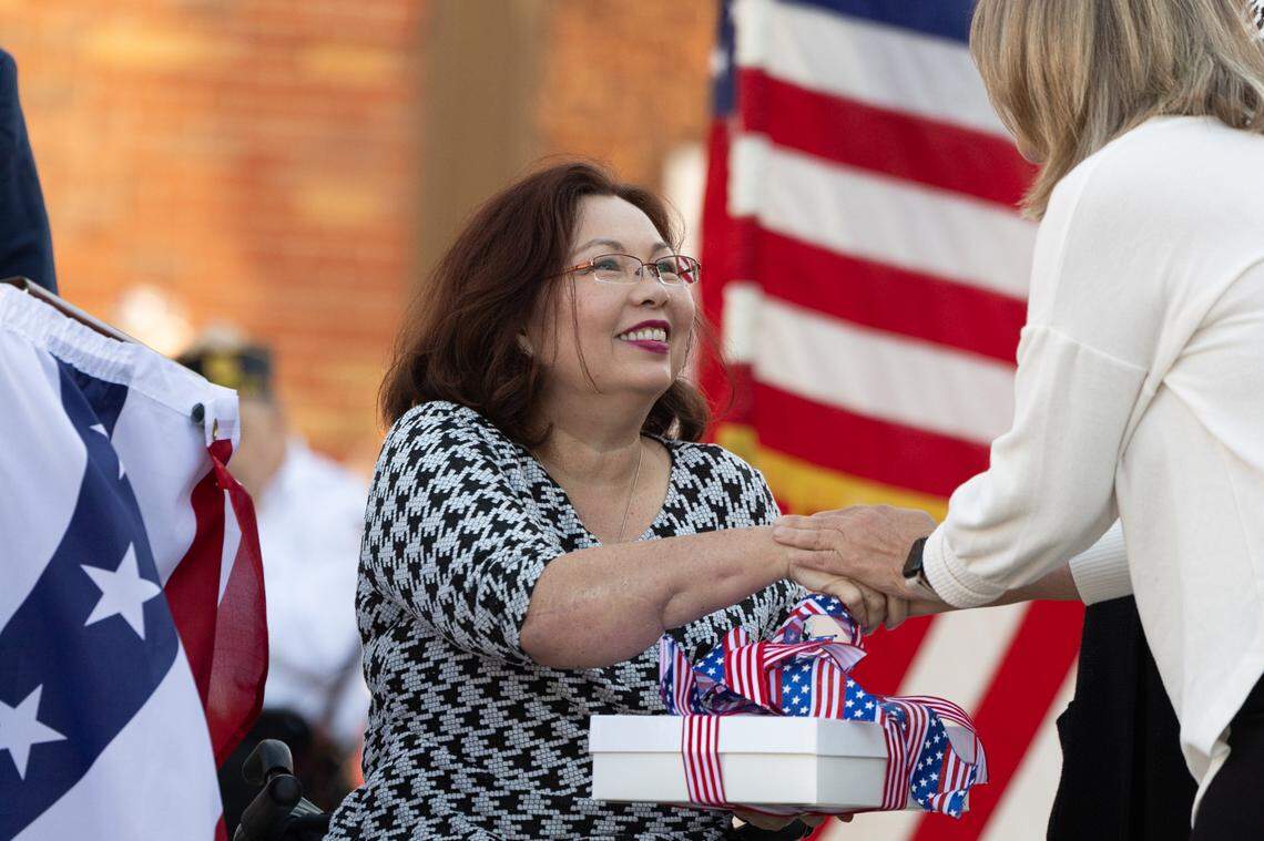Senator Tammy Duckworth accepts a gift from a local Belleville artist during Belleville’s 26th annual Veterans Day ceremony on Nov. 11, 2024.