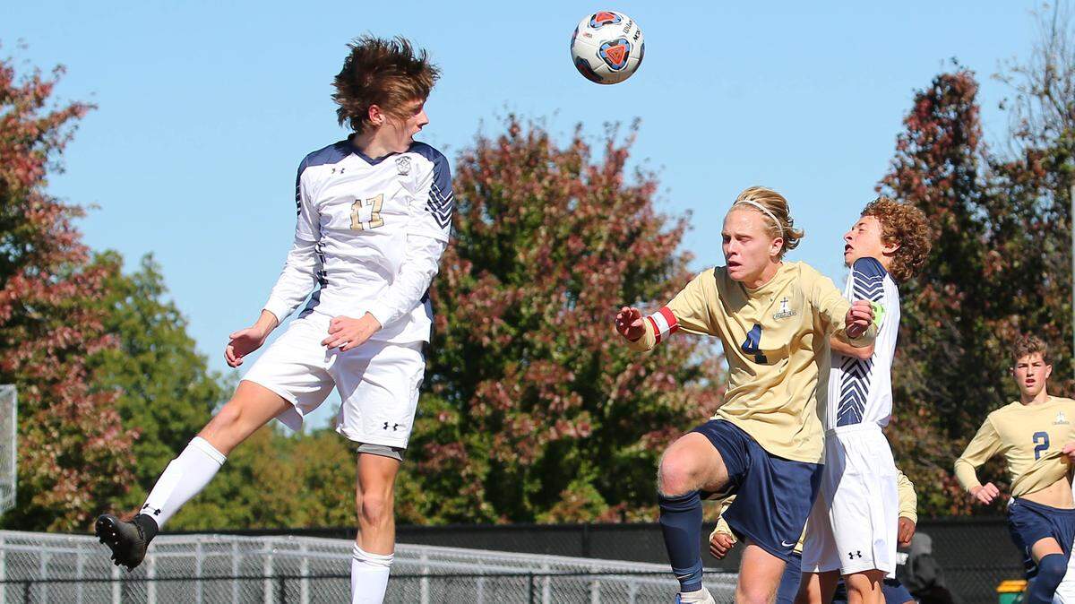 Althoff’s Mitchell Kidd goes for the ball against Father McGivney in the sectional soccer game Saturday in Belleville.